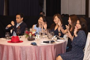 company annual dinner and dance toasting over roundtable in a hotel ballroom