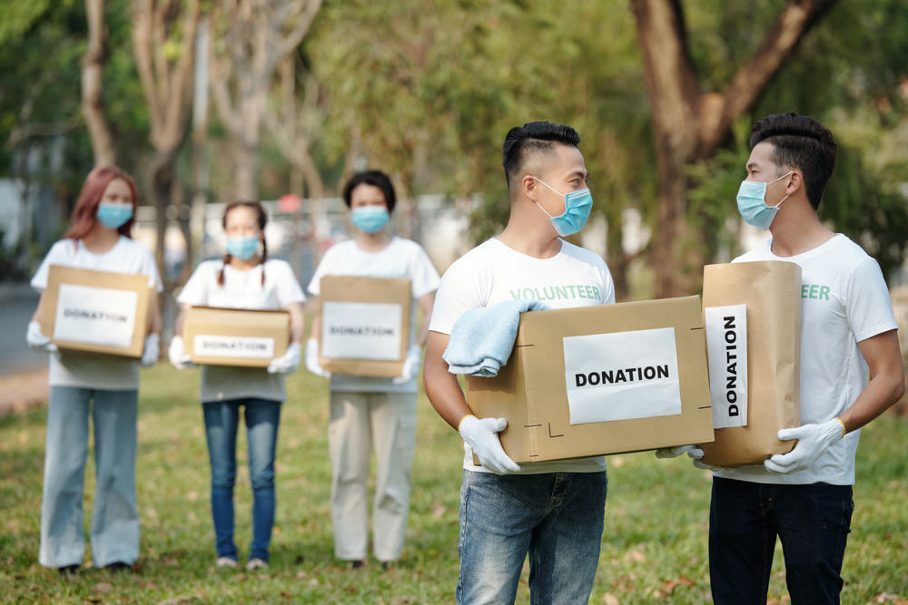 group of volunteers holding boxes for donation